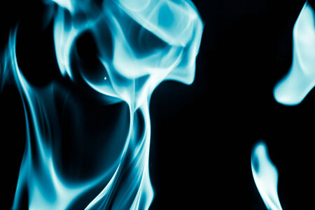 abstract background of blue flame fire on black backgroundの写真素材