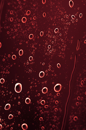 brown water drops on glassの写真素材