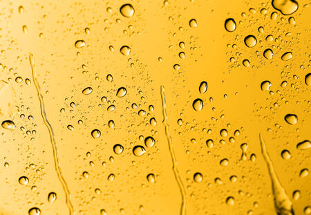 water drops on glass with goldの写真素材