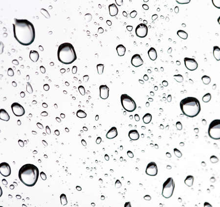 Drops of rain on the inclined window (glass).