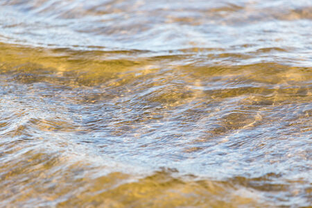 Background of the surface water on the shoreの写真素材