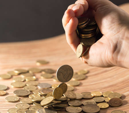 coins on the table and in hand