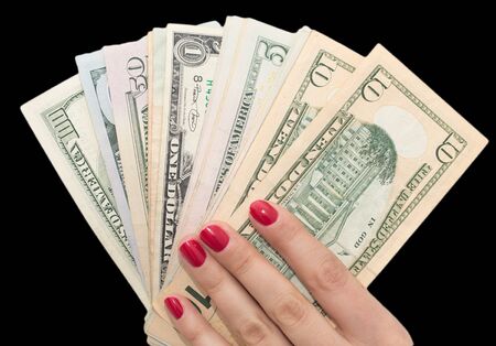 dollars in hand with red manicureの写真素材