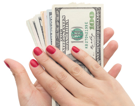dollars in hand with red manicureの写真素材