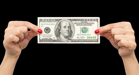 dollars in hand with red manicureの写真素材