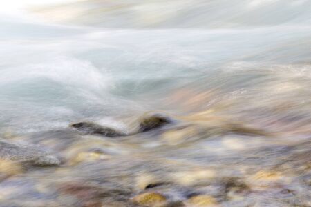 background of turbulent water in the mountain riverの写真素材