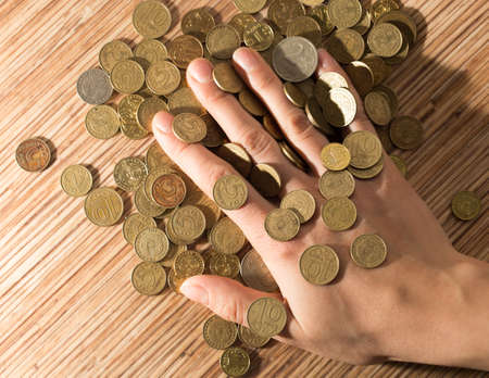 coins on the table and in hand