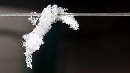 snow on the fence. close-upの写真素材