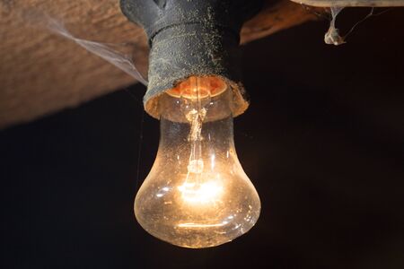 old lamp burning on a wooden ceilingの写真素材