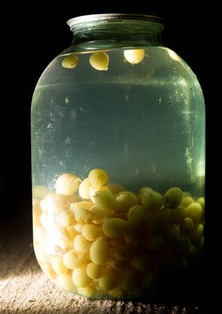 old bank with grape compote in the basement in the darkの写真素材