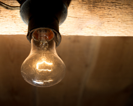 old lamp burning on a wooden ceilingの写真素材
