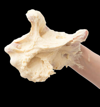 dough in hand on a black backgroundの写真素材
