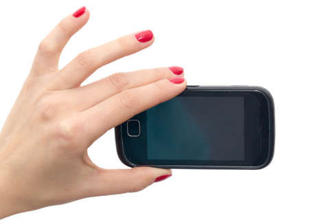Elegant female hands with red nails holding a smart phone. Closeup isolated on white