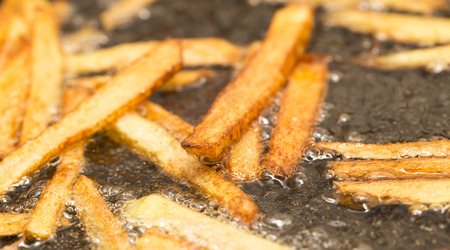 French fries fried in a panの写真素材