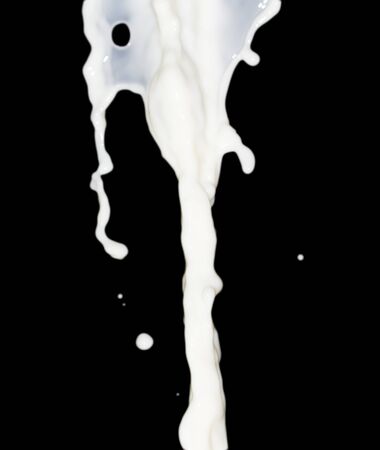 milk splash on black backgroundの写真素材