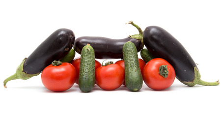 cucumbers, tomatoes and eggplant on a white backgroundの写真素材