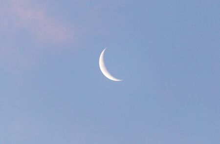 the moon in the sky at dawnの写真素材