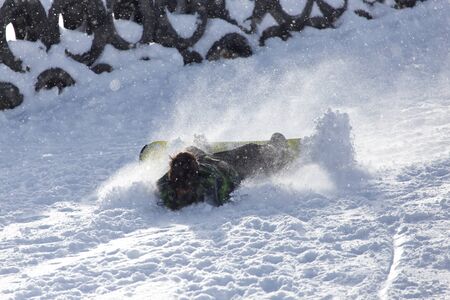 Snowboarder fell in the snow