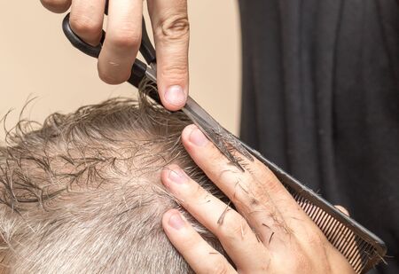 Men\'s hair cutting scissors in a beauty salonの写真素材