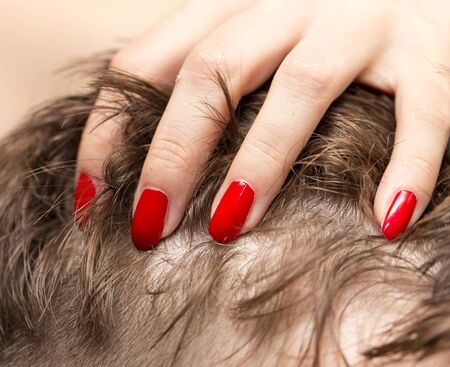 red manicure on her hairの写真素材