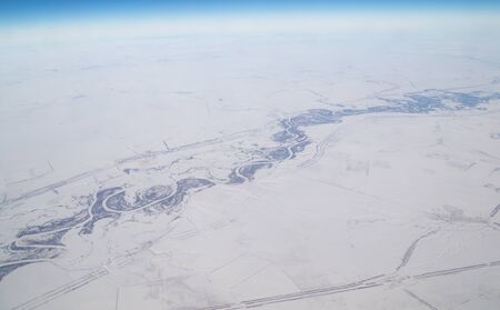 River in winter. view from the airplaneの写真素材