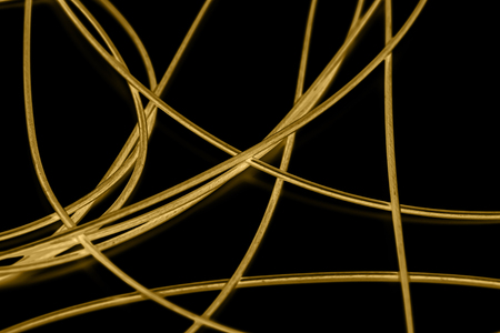 yellow cable on the black background. The inversionの写真素材