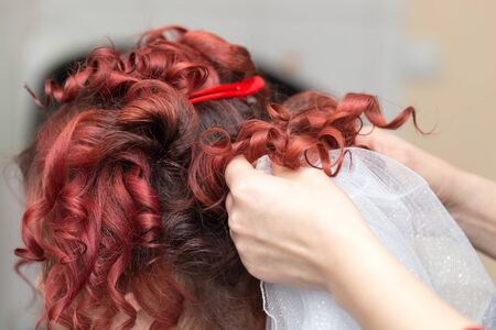 Wedding hairstyles with veil in the beauty salonの写真素材