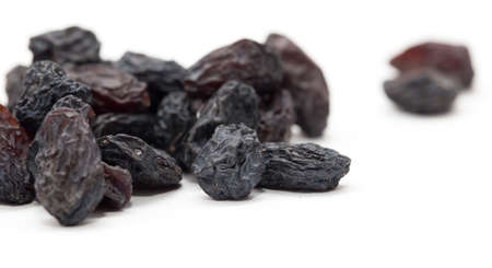 Black raisins on a white background. macroの写真素材