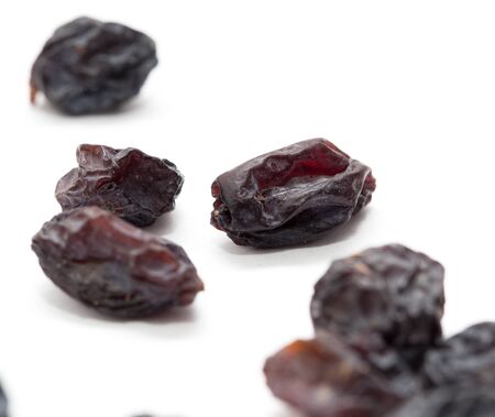 Black raisins on a white background. macroの写真素材