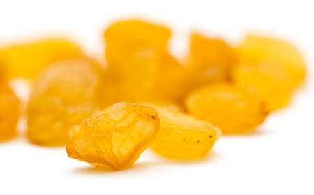 Golden raisins on a white backgroundの写真素材