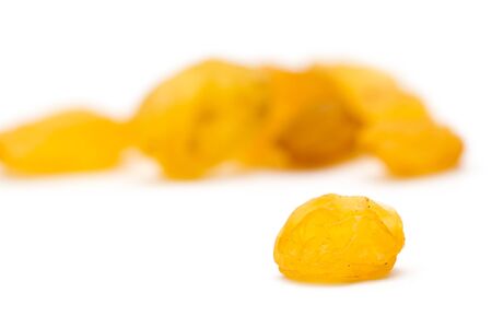 Golden raisins on a white backgroundの写真素材