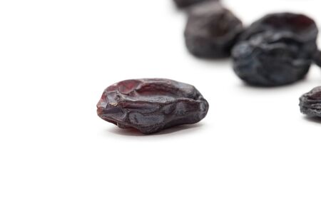 Black raisins on a white background. macroの写真素材