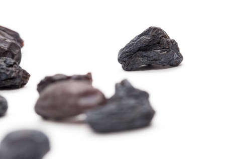 Black raisins on a white background. macroの写真素材