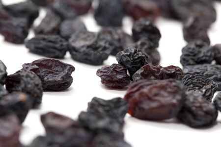 Black raisins on a white background. macroの写真素材