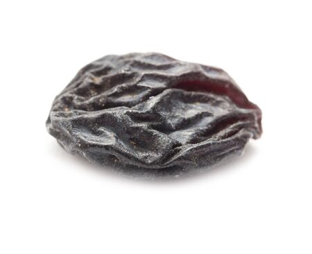Black raisins on a white background. macroの写真素材