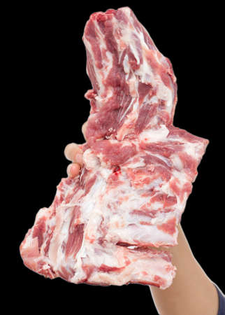 fresh meat in hand on a black backgroundの写真素材