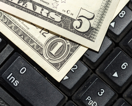 Online business concept. USA dollars bank notes on laptop keyboardの写真素材