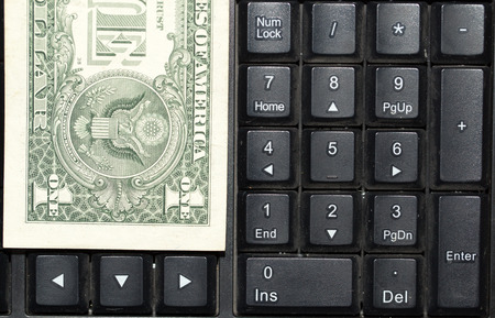 Online business concept. USA dollars bank notes on laptop keyboardの写真素材