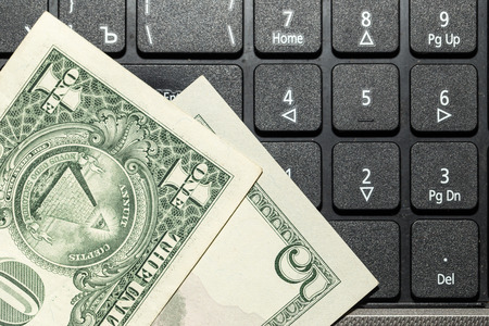 Online business concept. USA dollars bank notes on laptop keyboardの写真素材