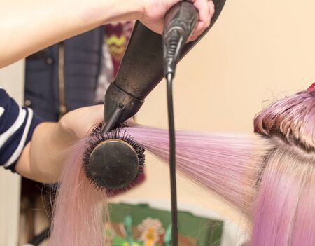 blow-drying hair in a beauty salonの写真素材