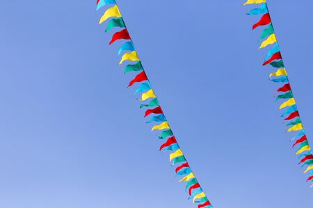 multicolored flags against the blue skyの写真素材