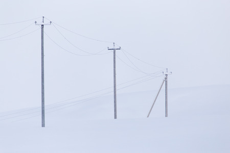 landscape with electric line castelluccio in the snowの写真素材