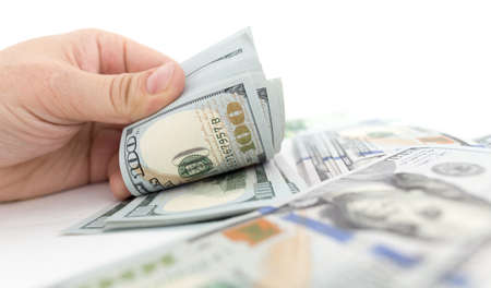 Dollars in hand on a white background