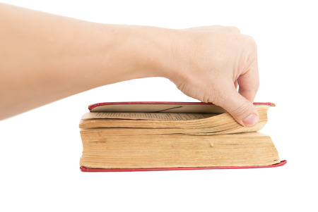 old book in his hand on a white backgroundの写真素材
