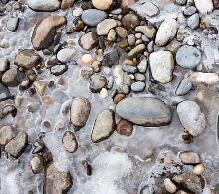 Stones in the ice on the natureの写真素材