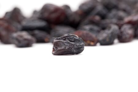 Black raisins on a white background. macroの写真素材