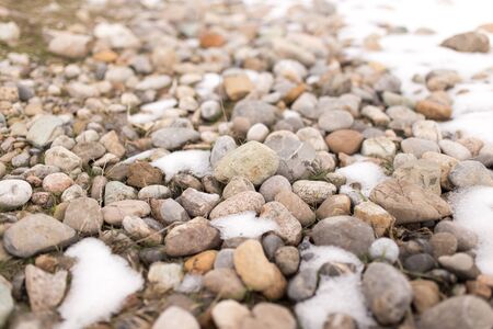 stones in the snow on the natureの写真素材