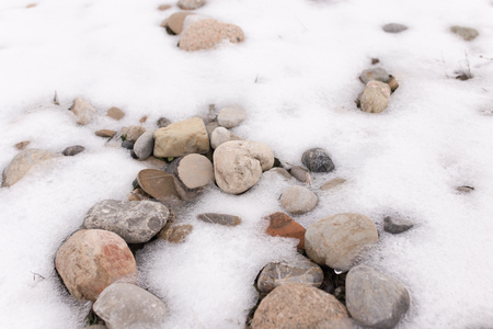 stones in the snow on the natureの写真素材