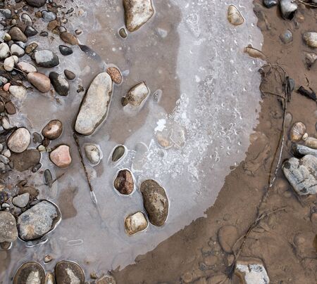 Stones in the ice on the natureの写真素材