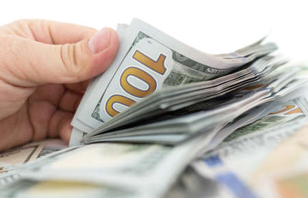 Dollars in hand on a white backgroundの写真素材